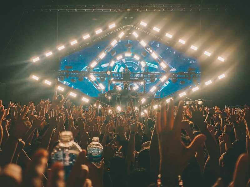 Concert crowd under a full stage lighting rig