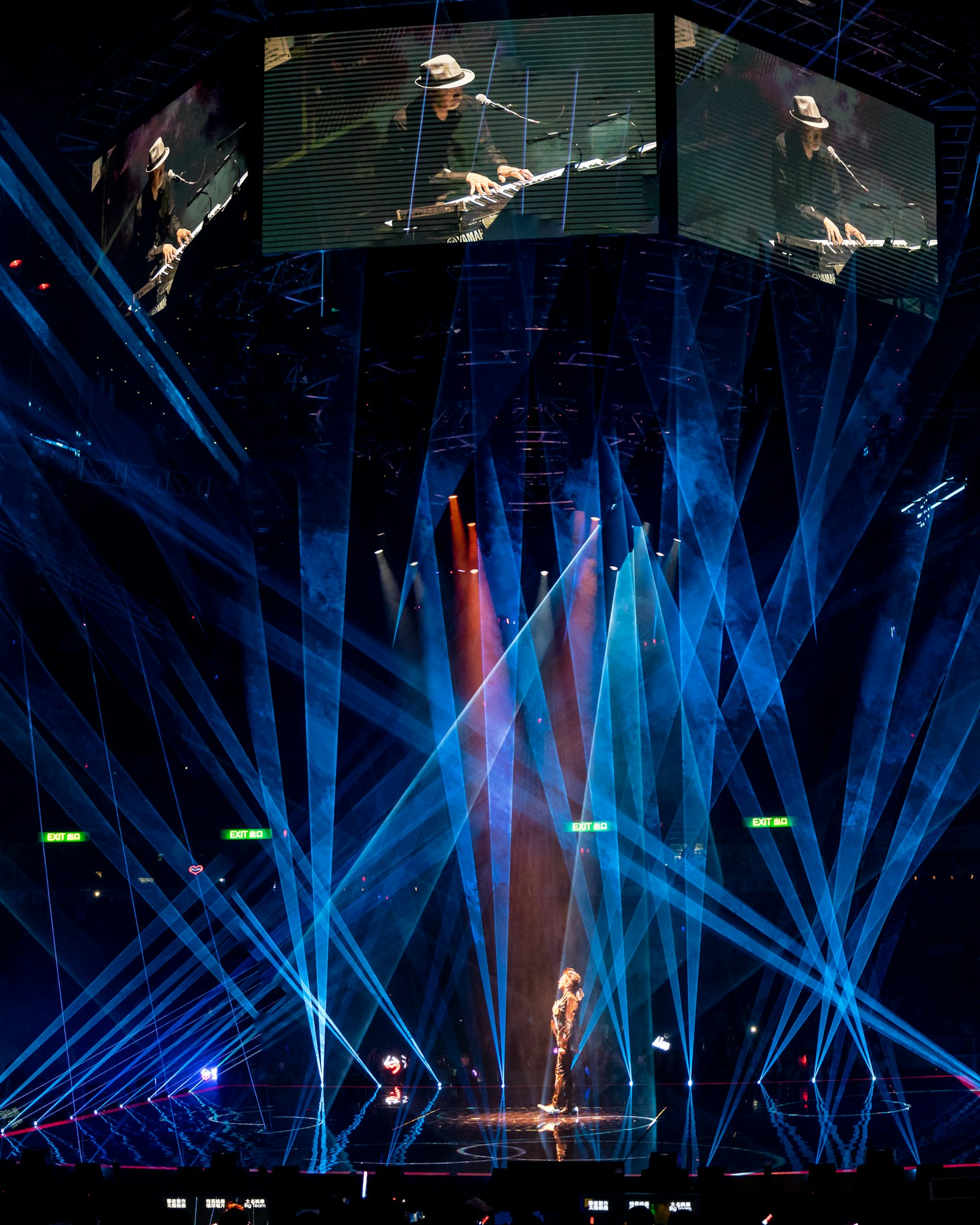 Beams of stage lighting cutting through haze at a live event